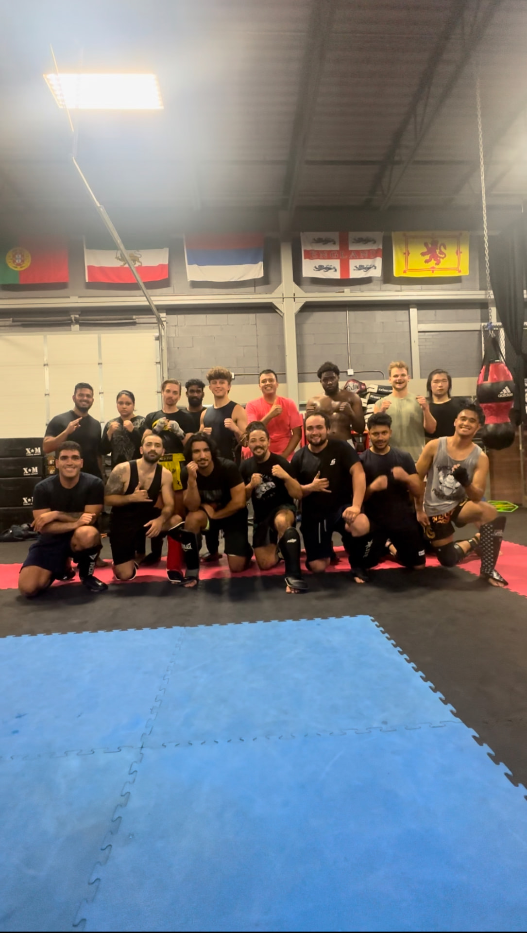 Matt and a group of training partners posing together on the gym mats
