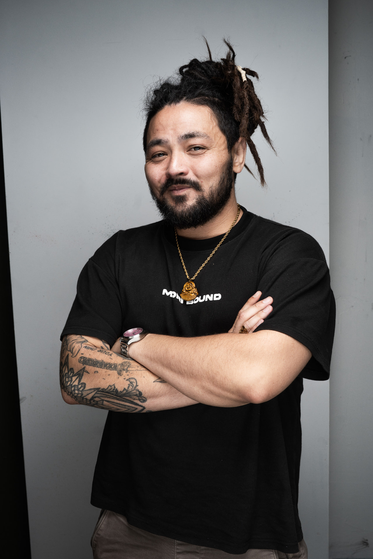 Matt Ayuen with his arms crossed and a relaxed expression