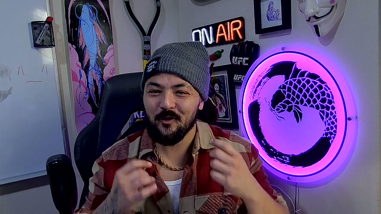 Matt Ayuen introducing himself beside his illuminated koi sign