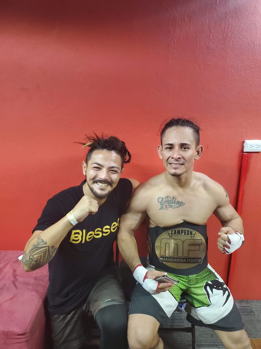 Matt with Carlos Mejía, who is wearing a championship belt