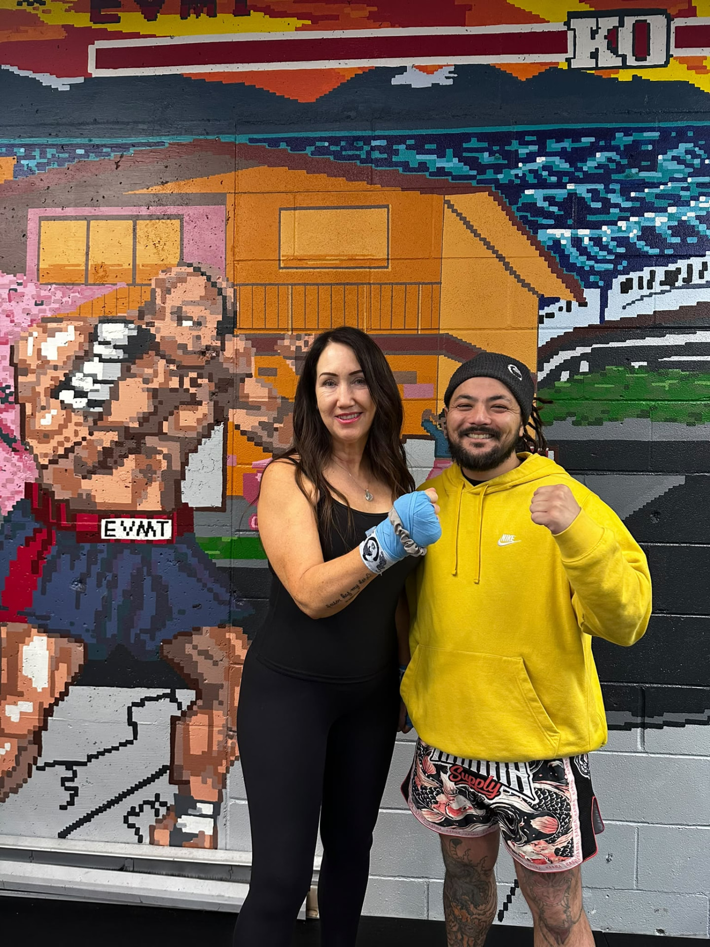 Shelley with Matt at East Van Muay Thai, both raising a fist